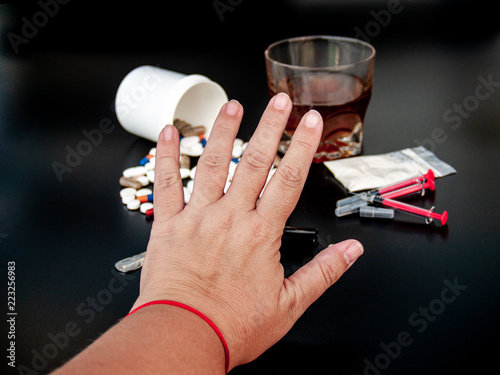 Billede på lærred A person gesturing with his hand stop drugs, Pills of different sizes, shapes an