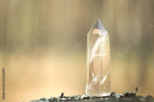 Large clear pure transparent great royal crystal of quartz chalcedony diamond brilliant on nature blurred bokeh background close up