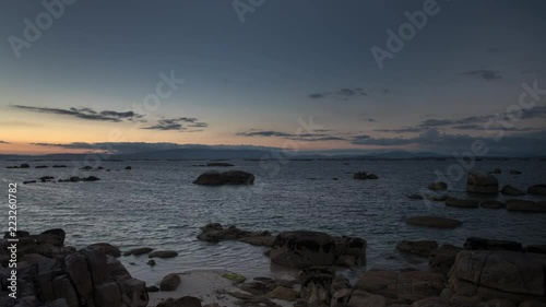 sunset timelapse of the beautiful beach of mexilloeira on the galician coast of spain on a summer day photo