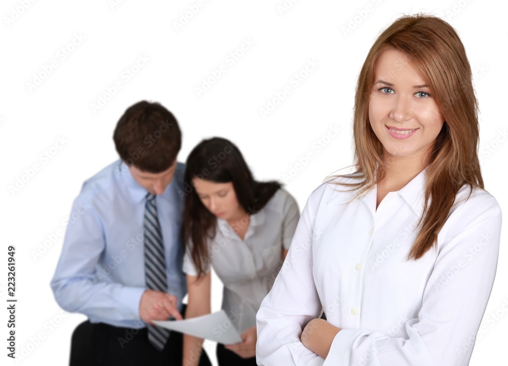 Friendly Businesswoman and Talking Collaborators in Background - Friendly Businesswoman and Talking Collaborators in Background -