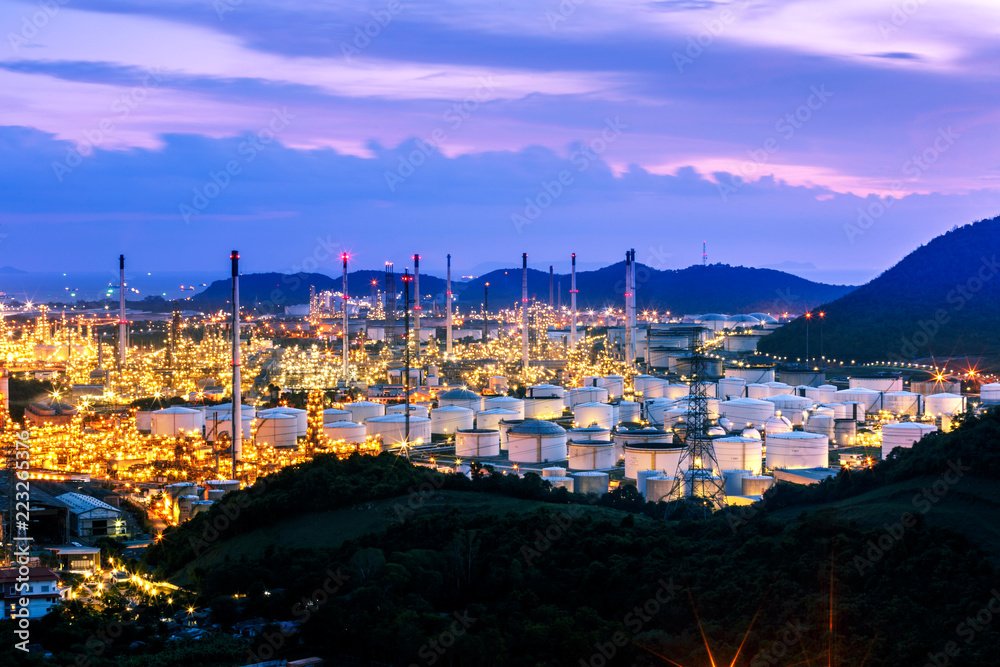 Refinery and tank farm in sunset with dramatic sky burst, exploration prove lighting, Chonburi Thailand