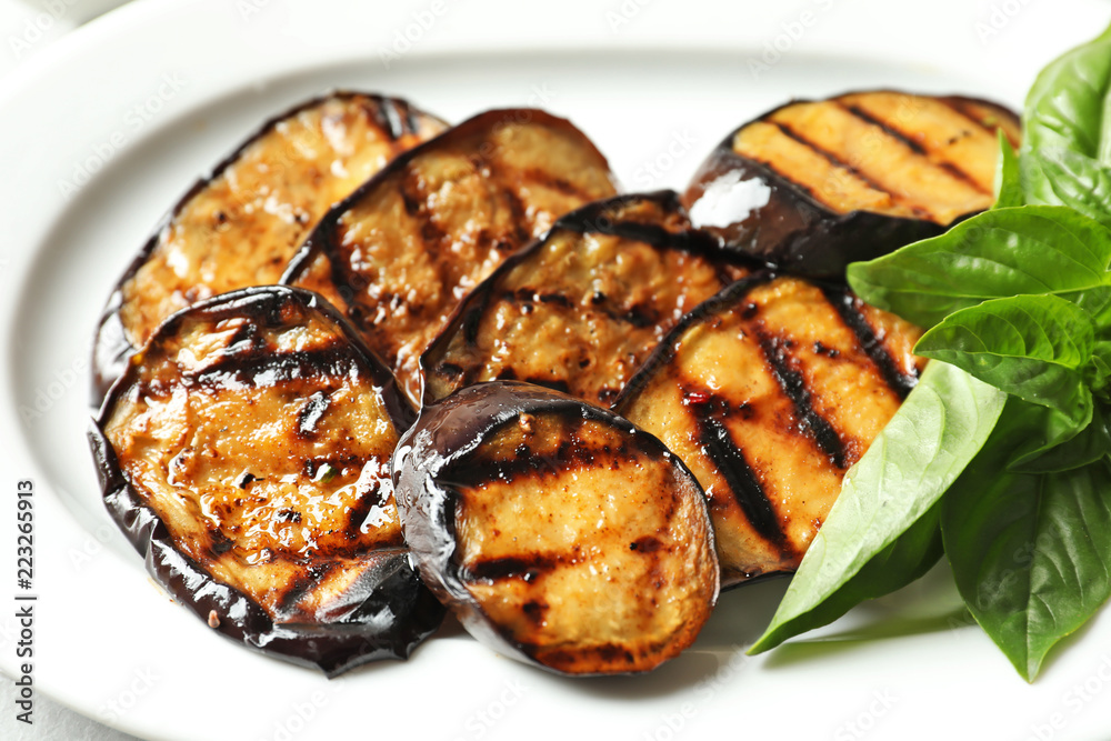 Plate with tasty fried eggplant slices, closeup