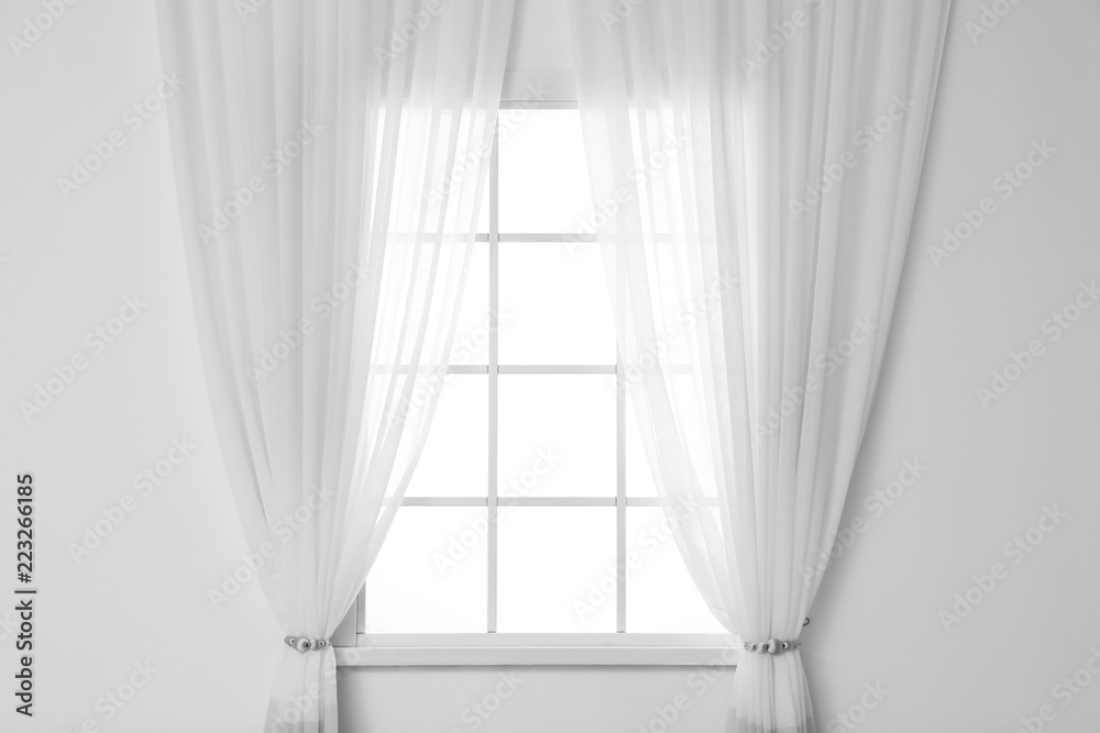 Fototapeta premium White wall with modern window and curtains indoors. Living room interior
