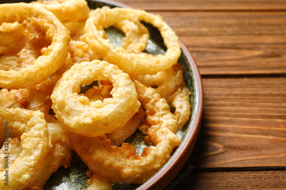 Homemade crunchy fried onion rings on wooden table, closeup Homemade crunchy fried onion rings on wooden table, closeup