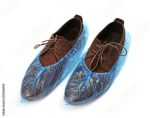 Pair of shoes in medical blue covers on white background
