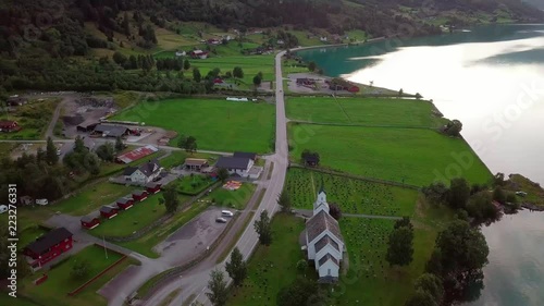 Car driving on Rv15, on the side of lake Oppstrynsvatnet, Aerial Tracking Shot photo