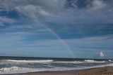 Double Rainbow on Beach with Cloudy Blue Sky