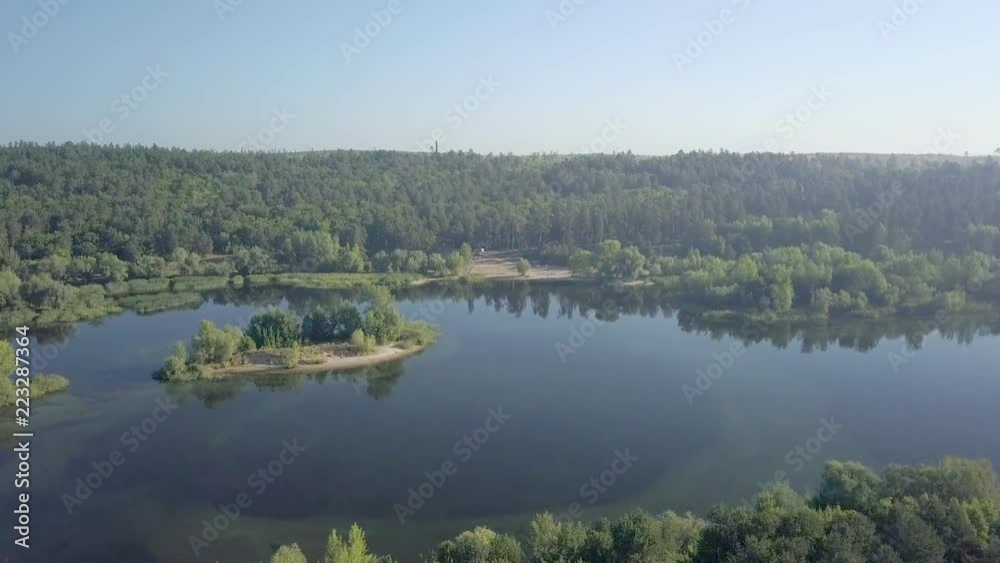 camera is flying over amazing calm river and coast with forest and high trees camera is flying over amazing calm river and coast with forest and high trees