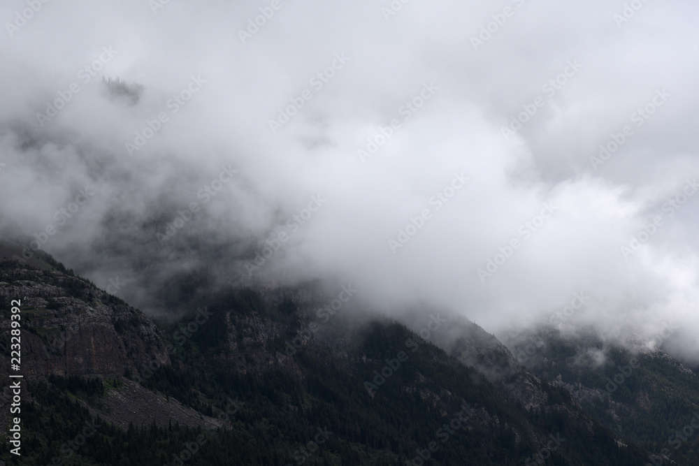 Misty clouds rise over mountain peaks in Waterton Lakes National Park, Canada