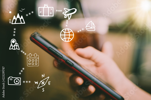 Travel vacation icons mixed screen on woman hand using smartphone to plan for long weekend.