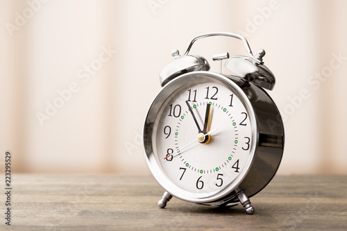 Retro alarm clock on blurred background
