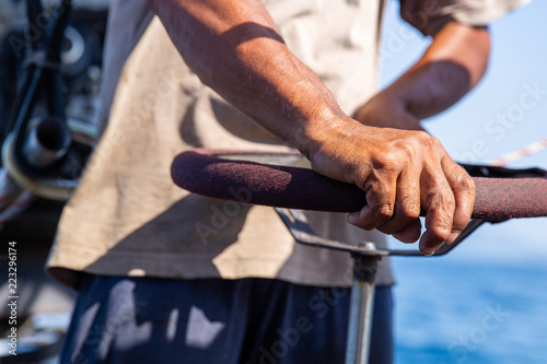 Close up of hands driving a boat