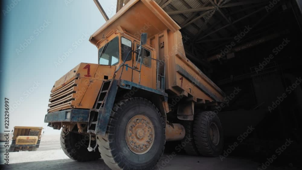 Industrial sand mining - Big loader working at sand area. Dolly Right - Dumping sand into a mill, Industrial machinery at sand quarry, 4K footage Industrial sand mining - Big loader working at sand area. Dolly Right - Dumping sand into a mill, Industrial machinery at sand quarry, 4K footage