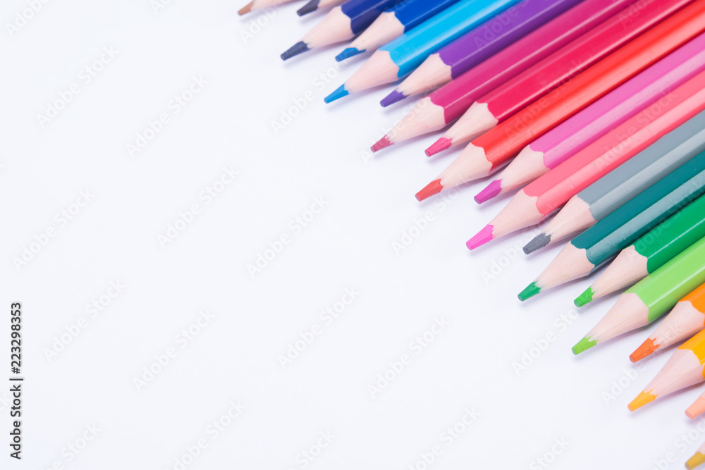 smooth, spread out colored pencils, in the right, top corner, on a white background