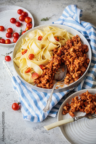 Pappardelle pasta with bolognese sauce and cherry tomatoes
