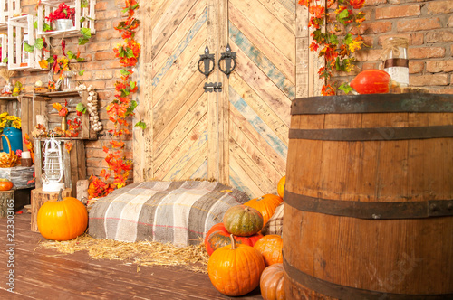 Autumn yellow leaves, pumpkins, autumn, straw, wooden door on the background. © jamie93