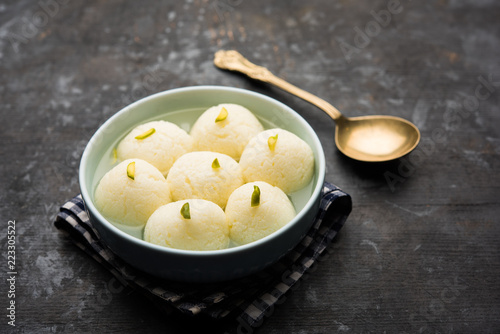 Indian Rasgulla or Rosogulla dessert/sweet served in a bowl. selective focus photo