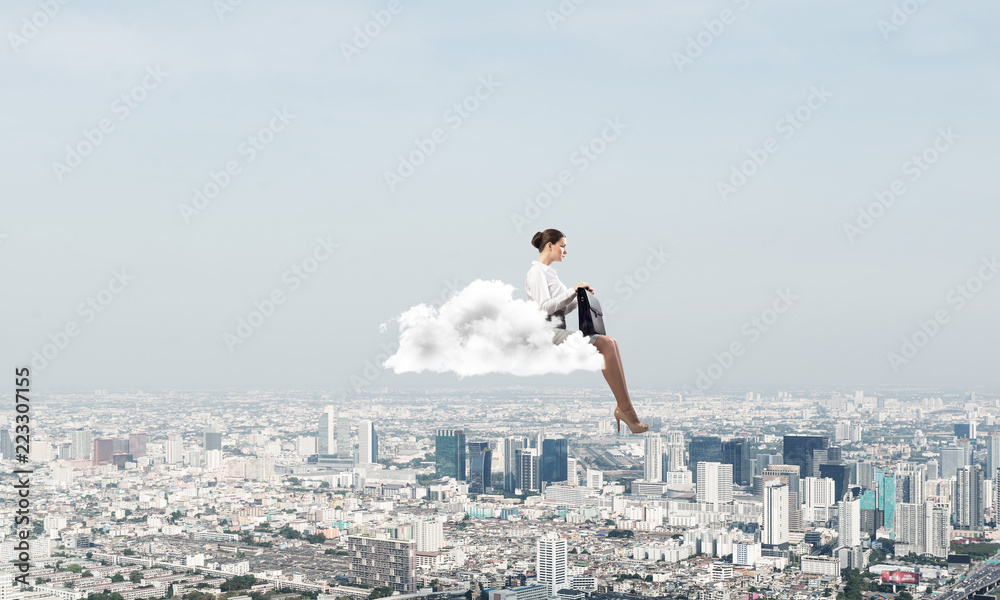 Businesswoman or accountant on cloud floating high above modern city Businesswoman or accountant on cloud floating high above modern city