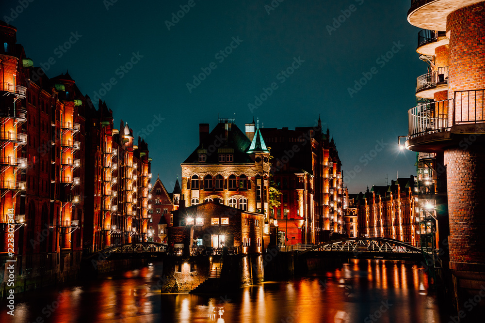 Hamburg, Germany. View of Wandrahmsfleet at dusk in light illumination. Located in Warehouse District -Speicherstadt Landmark of HafenCity quarter. Most visited touristic famous place