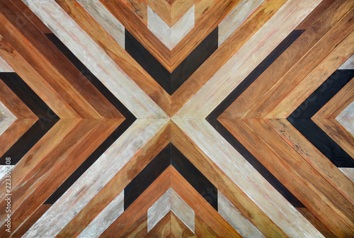 seamless yellow, black, white and dark brown color lumber in arrows or chevron pattern to the center for texture background. top view