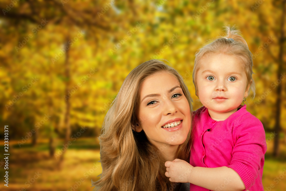 Mother and daughter portrait in autumn park
