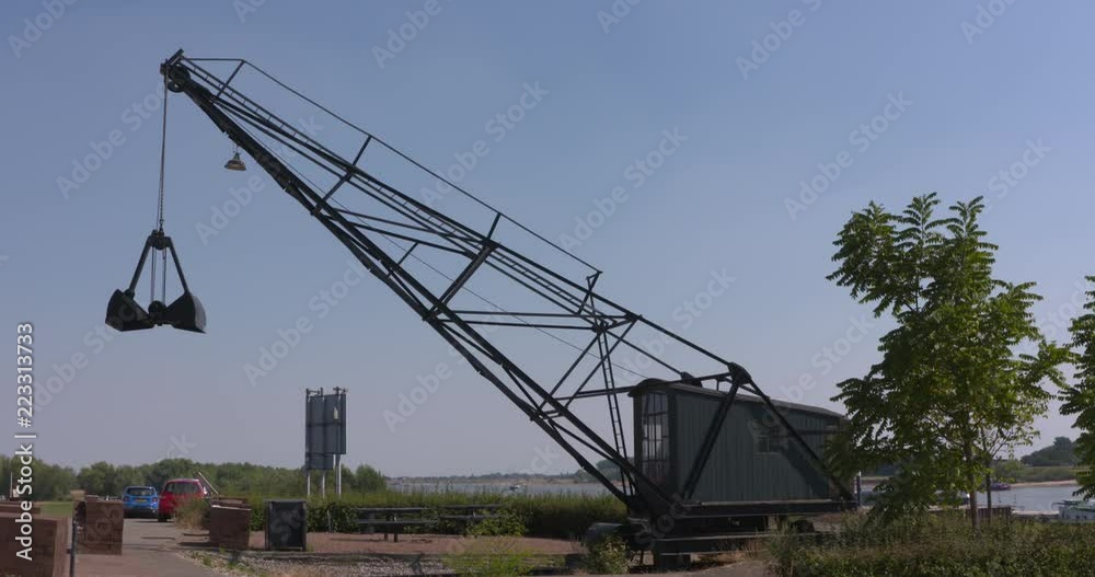 historic electric crane of a brickworks at the riverbank, used to load or discharge ships. SPIJK, THE NETHERLANDS - summer 2018 historic electric crane of a brickworks at the riverbank, used to load or discharge ships. SPIJK, THE NETHERLANDS - summer 2018
