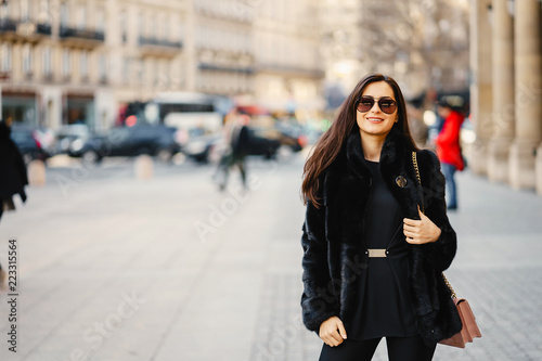 stylish girl walking through Paris