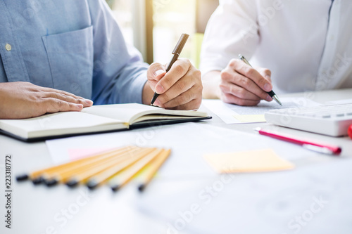 Tutor books with friends, Man sitting pointing studying together at desk with classmates exams, hands with books or textbooks writing to notebooks, learning, education and school concept