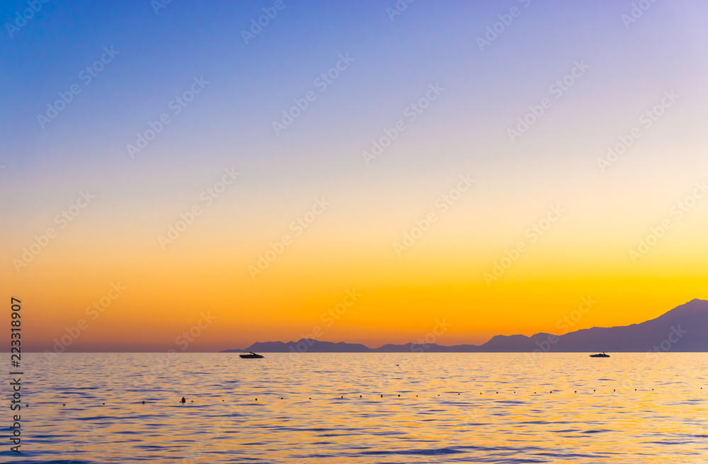 Beautiful sunset on calm sea with Lycian Olympus Mountains