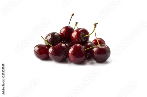 Fresh red cherries lay on white isolated background. Ripe cherry on a white background. Cherries with copy space for text.