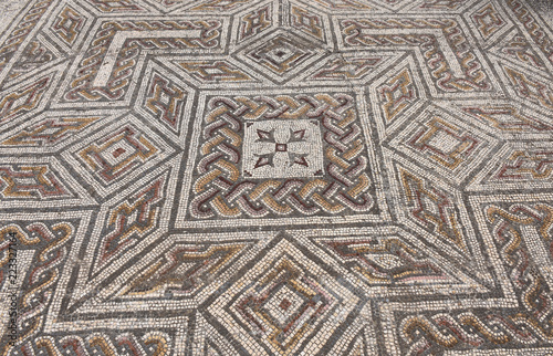 Geometric mosaic of the roman ruins of the ancient city of Conimbriga, Beiras region, Portugal photo