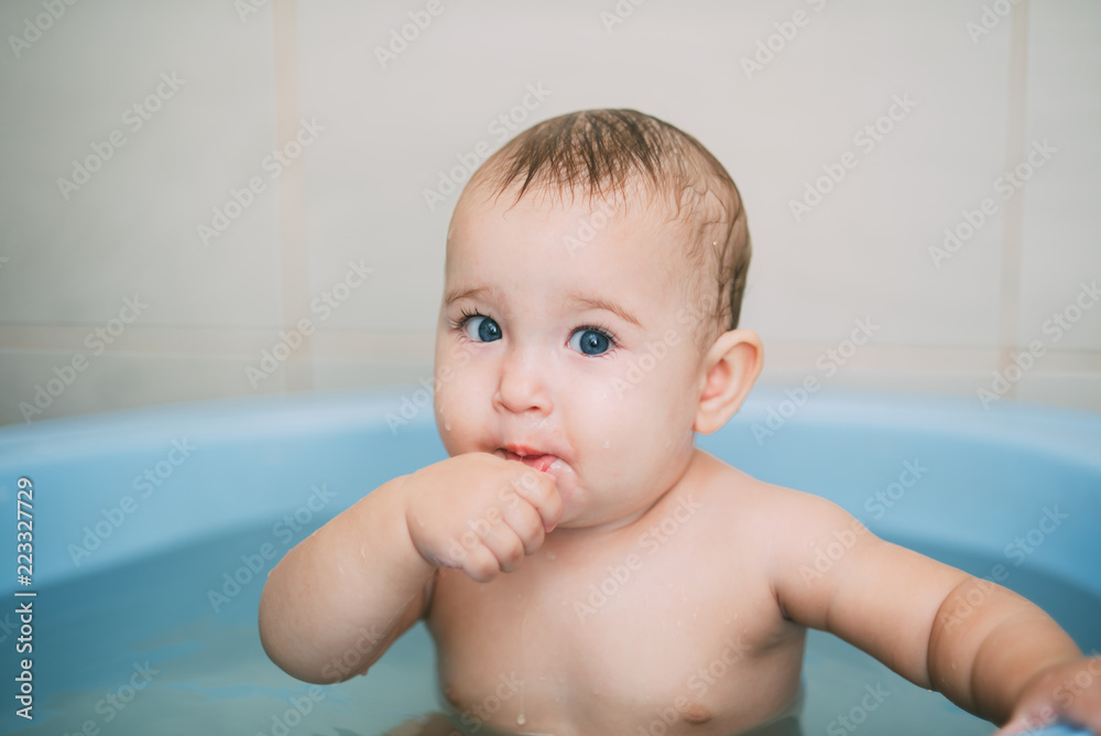 Girl having fun bathing in the bathroom in the basin Girl having fun bathing in the bathroom in the basin