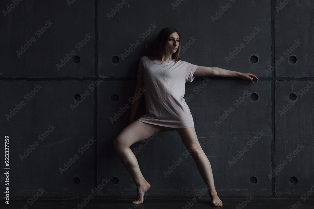 young beautiful woman professional dancer dancing during a rehearsal in a dance studio, modern dramatic style, experimental dance