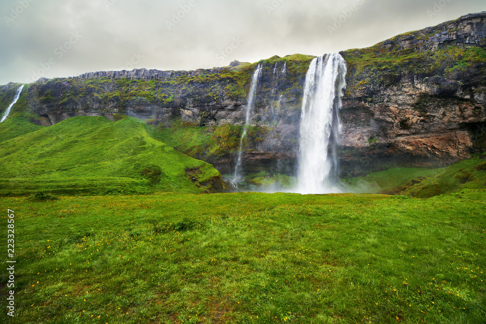 A waterfall in a beautiful Iceland landscape.