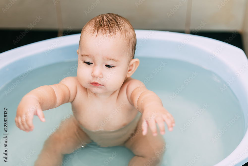 Girl having fun bathing in the bathroom in the basin Stock Photo | Adobe Stock