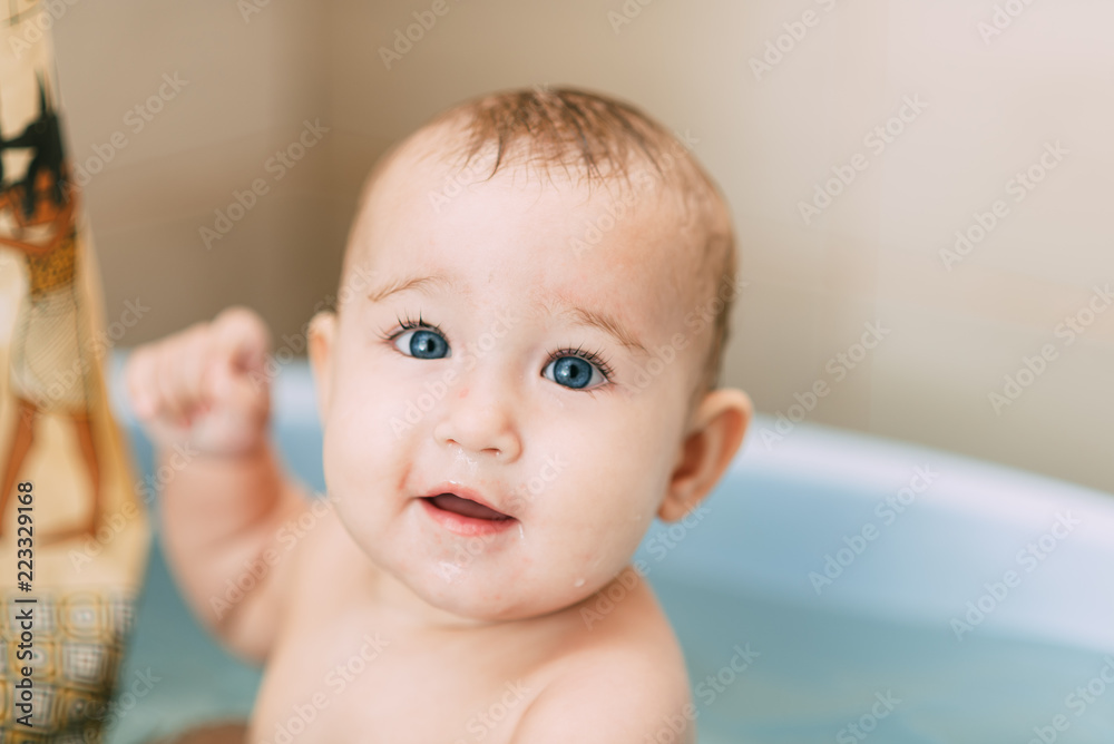 Girl having fun bathing in the bathroom in the basin Girl having fun bathing in the bathroom in the basin