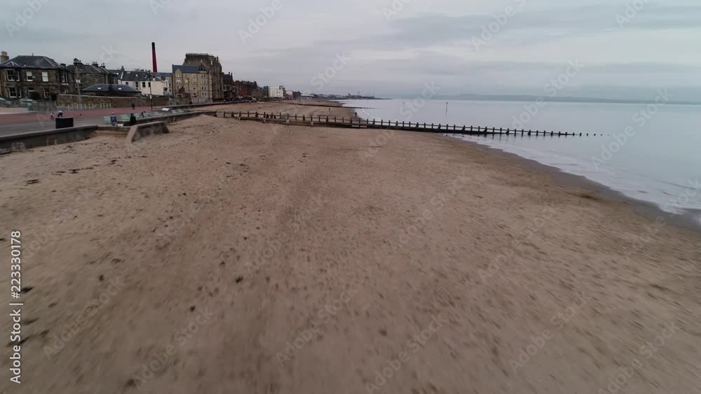 Flying over Portobello beach on a cloudy day. Rising up to give a view of the historic town centre. Flying over Portobello beach on a cloudy day. Rising up to give a view of the historic town centre.