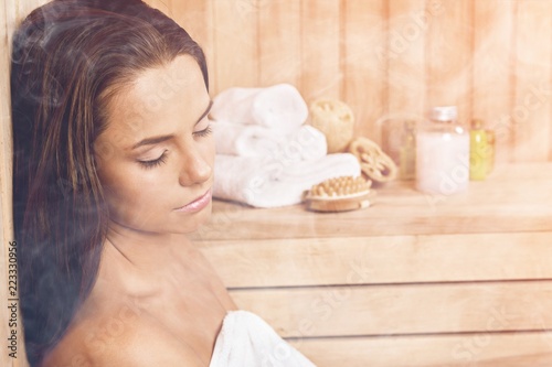 Young beautiful relaxed woman in sauna