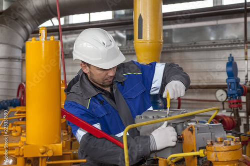 The mechanic - the repairman , operator production gas, Oil, gas industry. gas conditioning equipment and valve armature