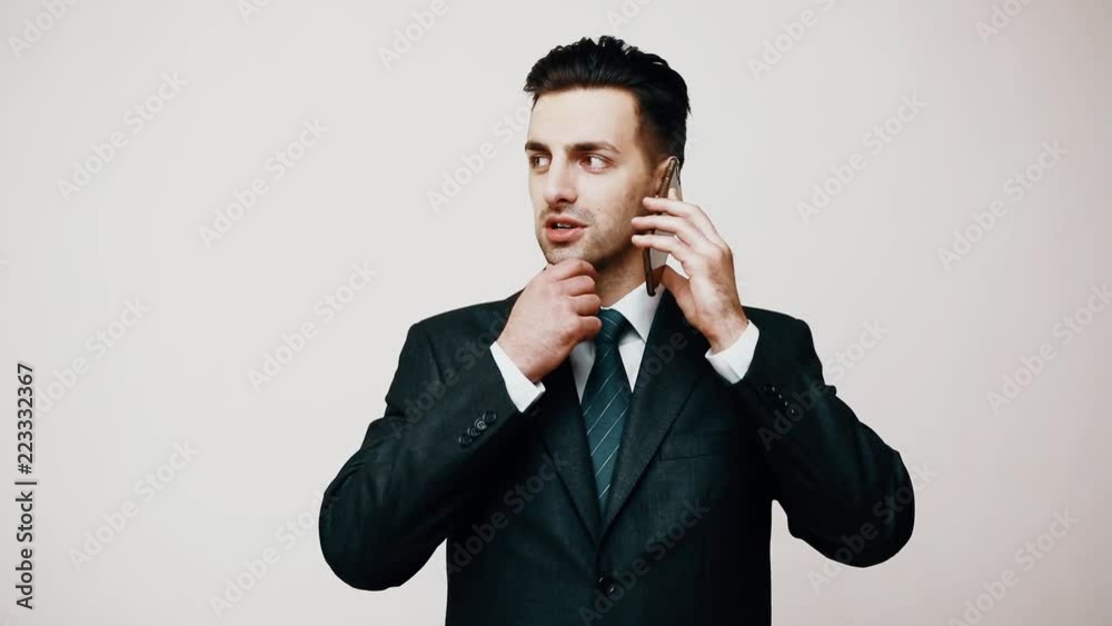 Handsome business man talk on cell mobile phone isolated over white background. Handsome business man talk on cell mobile phone isolated over white background.