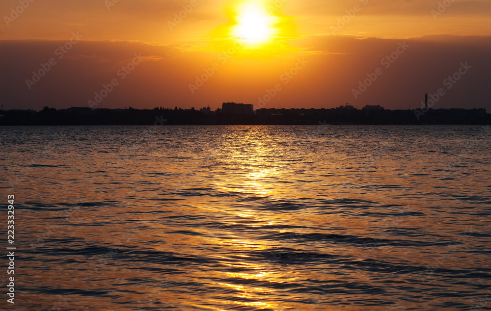 Sunset on the water, the sun sets over the horizon