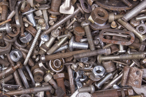 Old bolts and nuts texture. Rusty and dusty bolts and nuts. Chrome bolts and nuts.