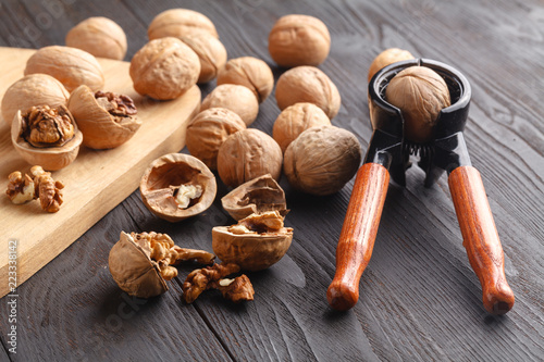 nutcracker and walnuts on a wooden background