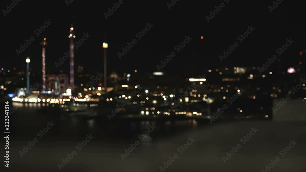 A dolly shot and focus pull focusing on amusement park Gröna Lund in Stockholm, Sweden at night.