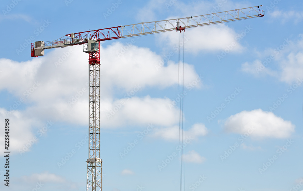 red and white crane at light blue sky background