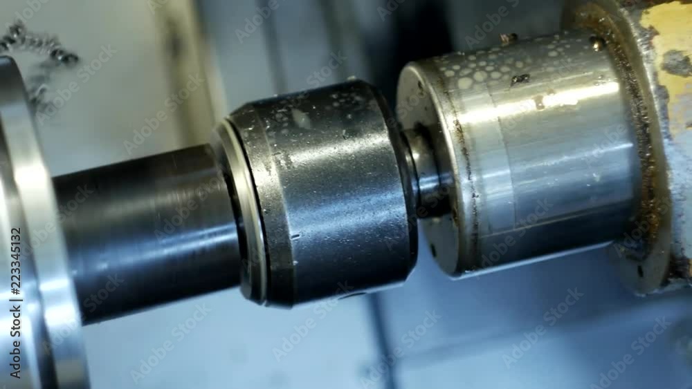 CNC lathe pulls out part of metal workpiece pulley, modern lathe for metal processing, close-up, production CNC lathe pulls out part of metal workpiece pulley, modern lathe for metal processing, close-up, production