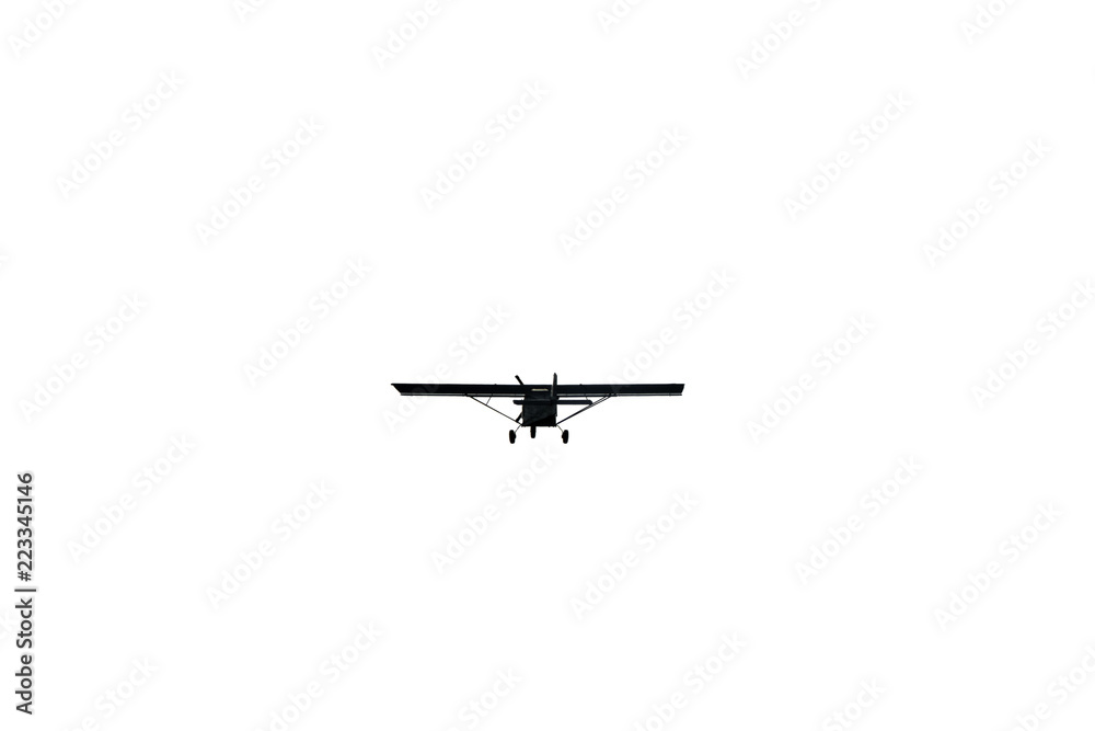 Light aircraft flying over white sky background Light aircraft flying over white sky background