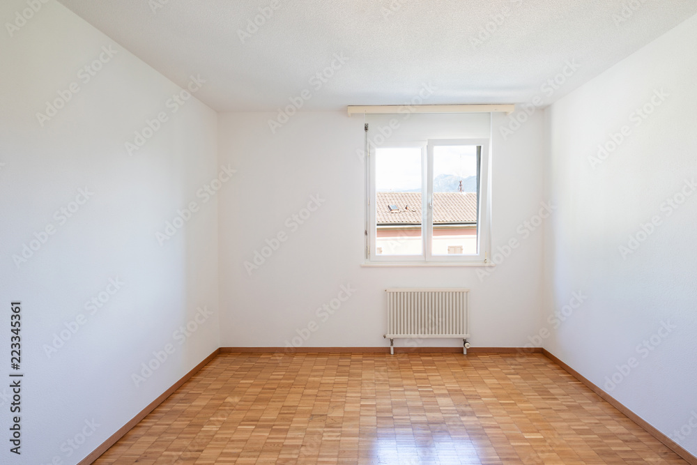 Empty room with window and parquet Empty room with window and parquet