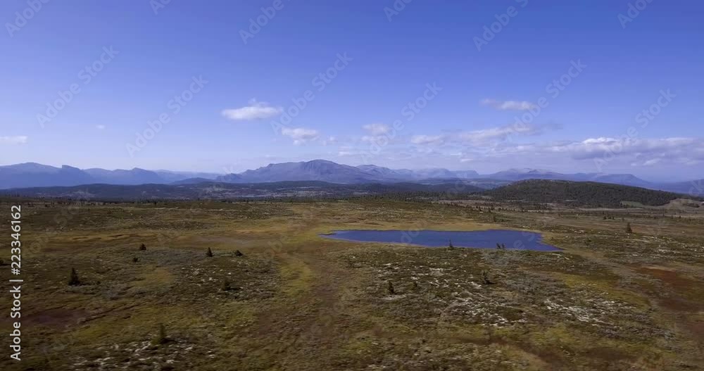 Right sliding aerial drone shot from Golsfjellet, a mountain located in Hallingdal, Norway. Nice little lake in the foreground. Right sliding aerial drone shot from Golsfjellet, a mountain located in Hallingdal, Norway. Nice little lake in the foreground.