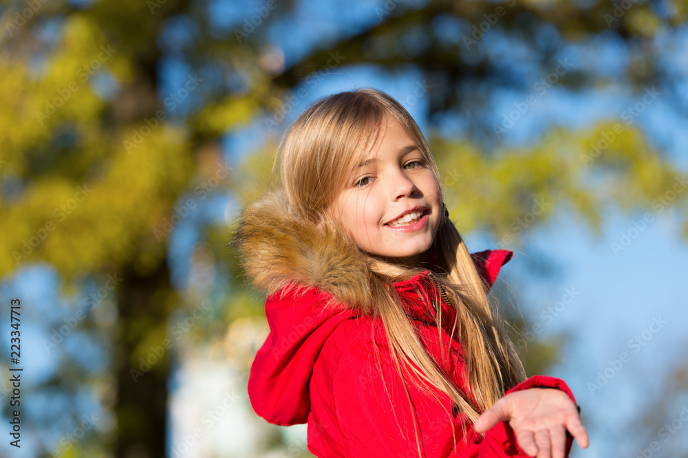 Happy small girl on fresh air. Small girl happy smiling in autumn woods. Small fashion model. Childhood fashion for autumn season. Stylish and cute. Brown tints of an autumn Happy small girl on fresh air. Small girl happy smiling in autumn woods. Small fashion model. Childhood fashion for autumn season. Stylish and cute. Brown tints of an autumn